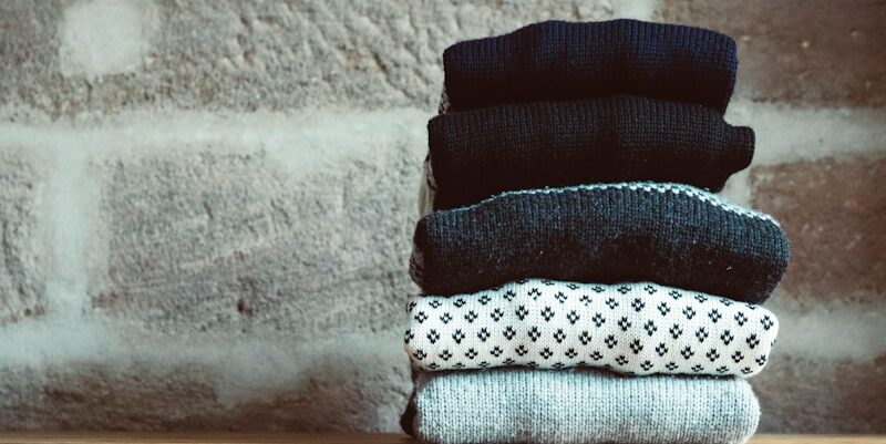 a stack of socks sitting on top of a wooden dresser